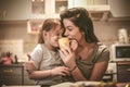 Mother and daughter have fun together. Mommy let me try coffee. Royalty Free Stock Photo