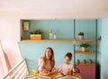 Mother and daughter having a breakfast with fresh squeezed juices in the cafe Royalty Free Stock Photo