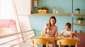 Mother and daughter having a breakfast with fresh squeezed juices in the cafe Royalty Free Stock Photo