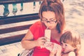 Mother and daughter having breakfast outdoors. Royalty Free Stock Photo