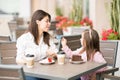 Mother and daughter having cake at restaurant Royalty Free Stock Photo