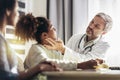 Mother And Daughter Having Consultation With Male Pediatrician In Hospital Office Royalty Free Stock Photo