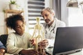 Mother And Daughter Having Consultation With Male Pediatrician In Hospital Office Royalty Free Stock Photo