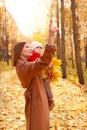 Mother and daughter having fun in autumn park. Happy family on walk. Royalty Free Stock Photo