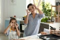 Mother and daughter having fun while cooking in kitchen Royalty Free Stock Photo