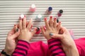 Mother and daughter having fun painting fingernails, view from above