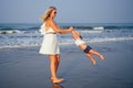 Mother daughter having fun resting on the beach. Family vacation travel . Caucasian female with toddler baby at ocean . Royalty Free Stock Photo