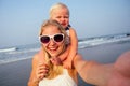 Mother daughter having fun resting on the beach. Family vacation travel . Caucasian female with toddler baby taking a Royalty Free Stock Photo