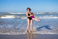 Mother and daughter having fun on sea beach on summer vacation. Family on sea rest. Happy people in swimwear on beach Royalty Free Stock Photo