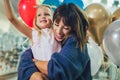 Mother and daughter having fun in shopping mall toghether