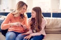 Mother And Daughter Having Fun Sitting On Sofa At Home Doing Nails Together Royalty Free Stock Photo