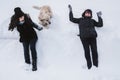 Mother and daughter having fun with their Golden Retriever in the snow Royalty Free Stock Photo