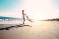 Mother and daughter having fun on tropical beach - Mum playing with her kid in holiday vacation next to the ocean - Family Royalty Free Stock Photo