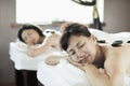 Mother and Daughter Having Hot Stone Massage Together Royalty Free Stock Photo