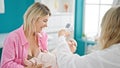 Mother and daughter having medical consultation measuring temperature at clinic Royalty Free Stock Photo
