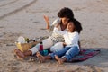 Mother and daughter having picnic on beach Royalty Free Stock Photo