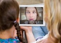 Mother and daughter having video calling in lving room Royalty Free Stock Photo