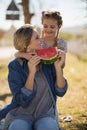 Mother and daughter having watermelon slice in park Royalty Free Stock Photo