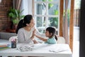 Mother and daughter high five during learing to read and write Royalty Free Stock Photo