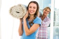 Mother and daughter holding a carpet Royalty Free Stock Photo