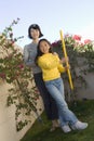 Mother And Daughter Holding Gardening Fork