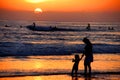 Mother and daughter holding hands on the beach in the sunset Royalty Free Stock Photo