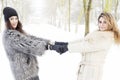 Mother and daughter holding hands in the snow Royalty Free Stock Photo