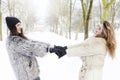 Mother and daughter holding hands in the snow Royalty Free Stock Photo
