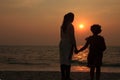 Mother and daughter holding hands  together during sunset Royalty Free Stock Photo