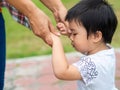 Mother and daughter holding hands walking in the park. Kid and M Royalty Free Stock Photo