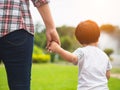 Mother and daughter holding hands walking in the park. Kid and M Royalty Free Stock Photo