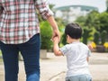 Mother and daughter holding hands walking in the park. Kid and M Royalty Free Stock Photo