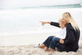 Mother And Daughter On Holiday Sitting On Beach Royalty Free Stock Photo