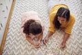 Mother And Daughter At Home Lying On Floor In Lounge Doing Jigsaw Puzzle Together Royalty Free Stock Photo