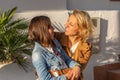 Mother and daughter hugging each other in mediterranean coastal town