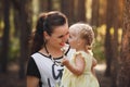 Mother and daughter hugging in love playing in the park. Warm sunny summer day Royalty Free Stock Photo