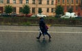 Mother and daughter hurry home in the pouring rain