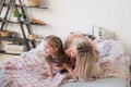 Mother and daughter jumping on bed, having fun together Royalty Free Stock Photo