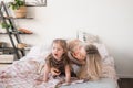 Mother and daughter jumping on bed, having fun together Royalty Free Stock Photo