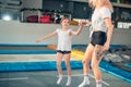 Mother and daughter jumping on trampoline and doing split Royalty Free Stock Photo