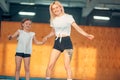 Mother and daughter jumping on trampoline and doing split Royalty Free Stock Photo