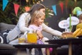 Mother and daughter on kids birthday party together Royalty Free Stock Photo