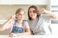 Mother with daughter in kitchen eating ice cream. Good relations of parent and child. Happy family concept Royalty Free Stock Photo