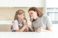 Mother with daughter in kitchen eating ice cream. Good relations of parent and child. Happy family concept Royalty Free Stock Photo