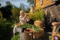 Two women, one young and the other older peel goldenrod flowers into a basket. Royalty Free Stock Photo