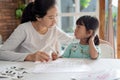 Mother and daughter learning to read and write letter at home Royalty Free Stock Photo