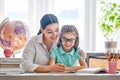 Mother and daughter are learning to write Royalty Free Stock Photo
