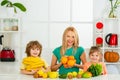 Mother daughter and little son blending cocktail with fruits. Healthy kids food. Royalty Free Stock Photo