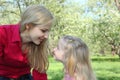 Mother and daughter look on each other