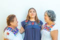 Mother and daughter looking at each other and  granddaughter in the middle of them Royalty Free Stock Photo